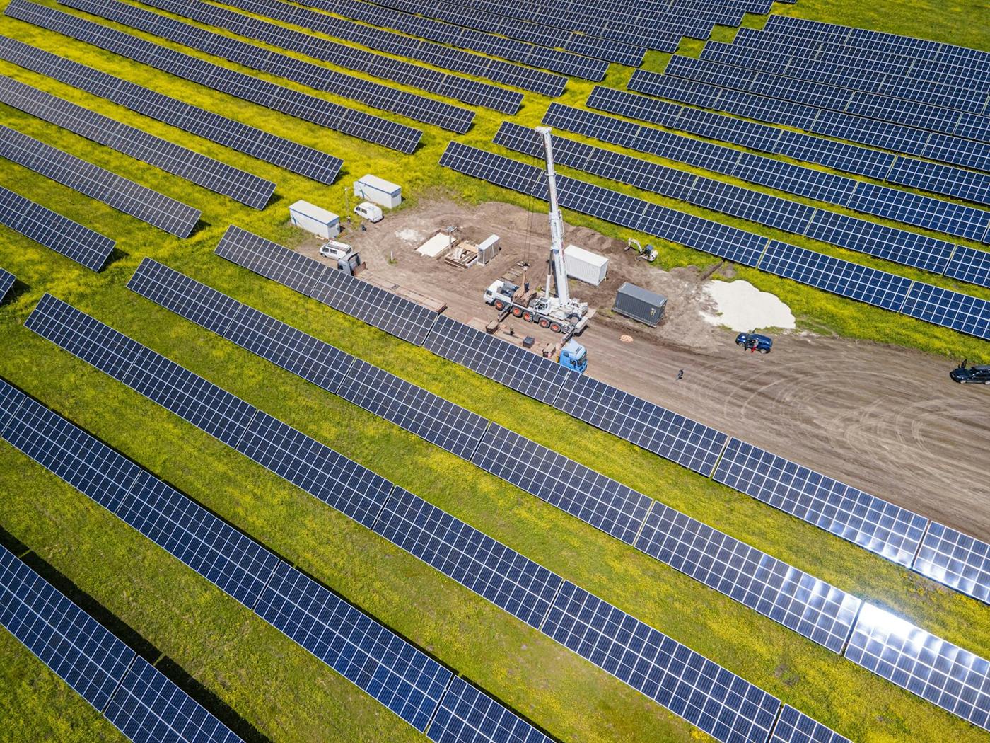 Aerial view of rows of solar modules at a ground-mounted solar plant